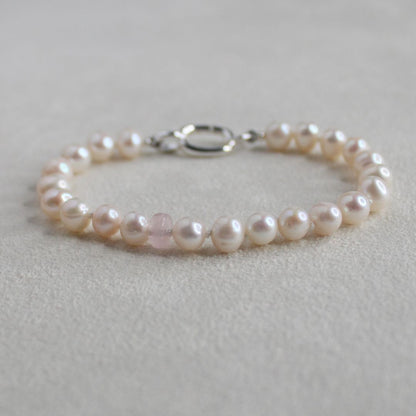 white pearl and morganite Pearl bracelet on a light  creamy  background